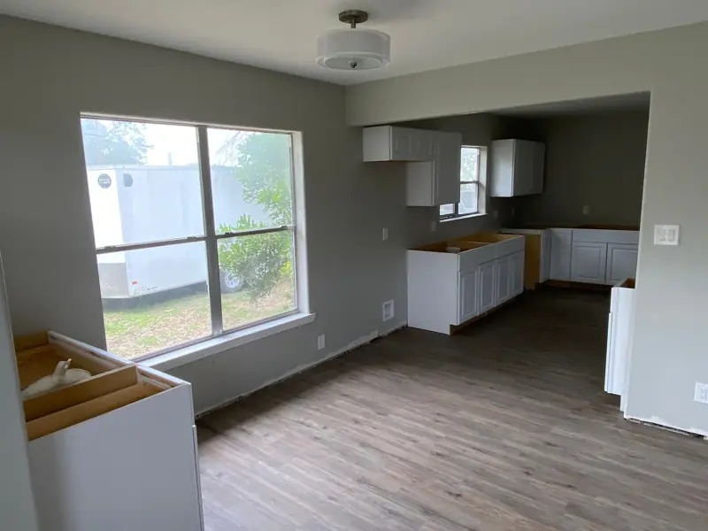 Dining area and kitchen with the new floor and cabinets.