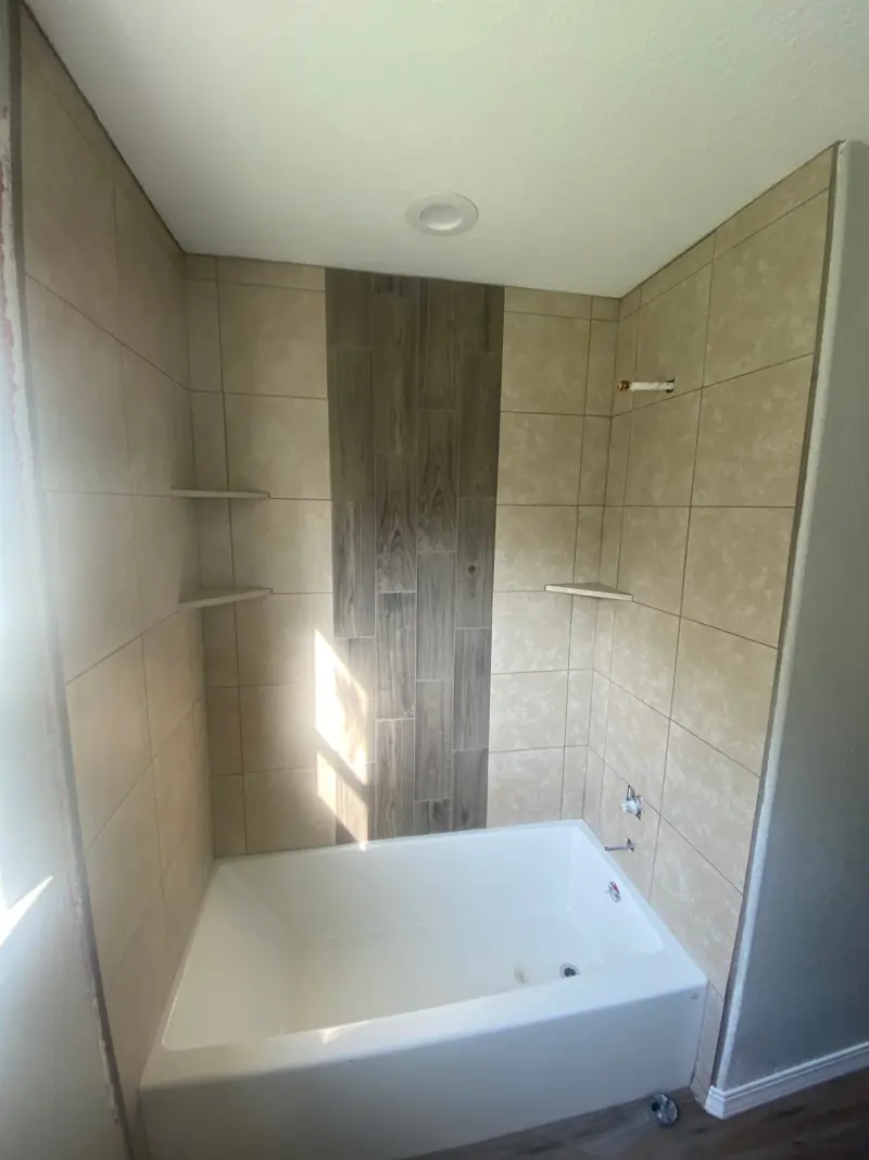 Tile tub surround with a wood-look tile stripe.
