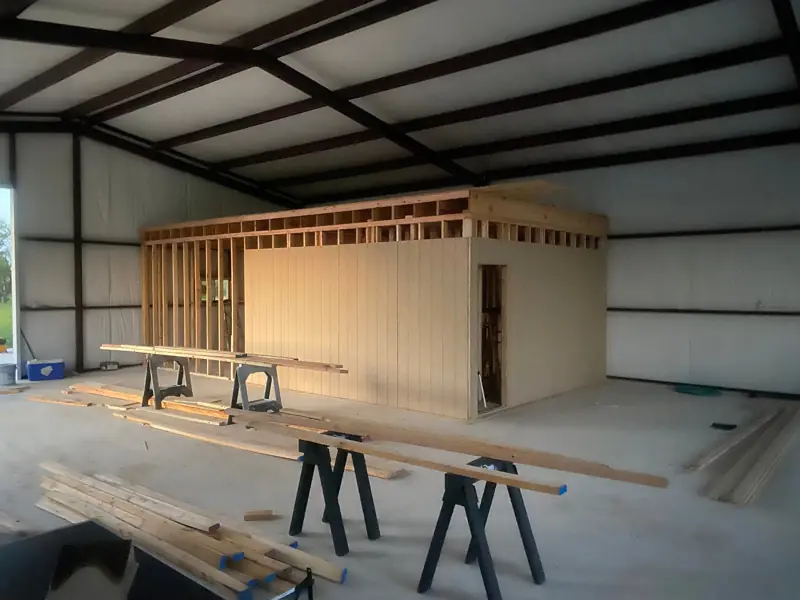 Office framed and paneled inside a steel shop building.