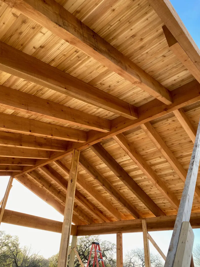 Cedar tongue-and-groove ceiling boards under the rafters.