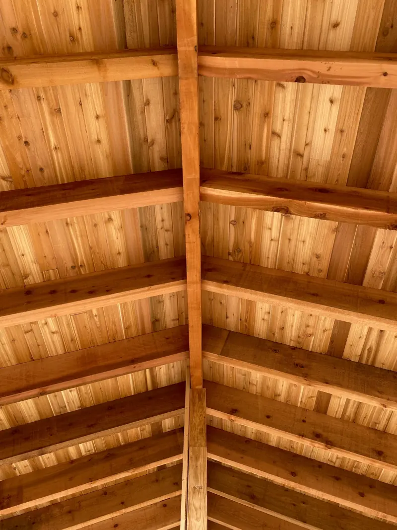 Cedar ceiling boards up to the ridge, seen from below.