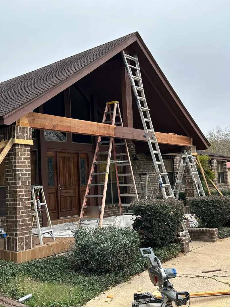 New cedar timber beam across the porch gable.