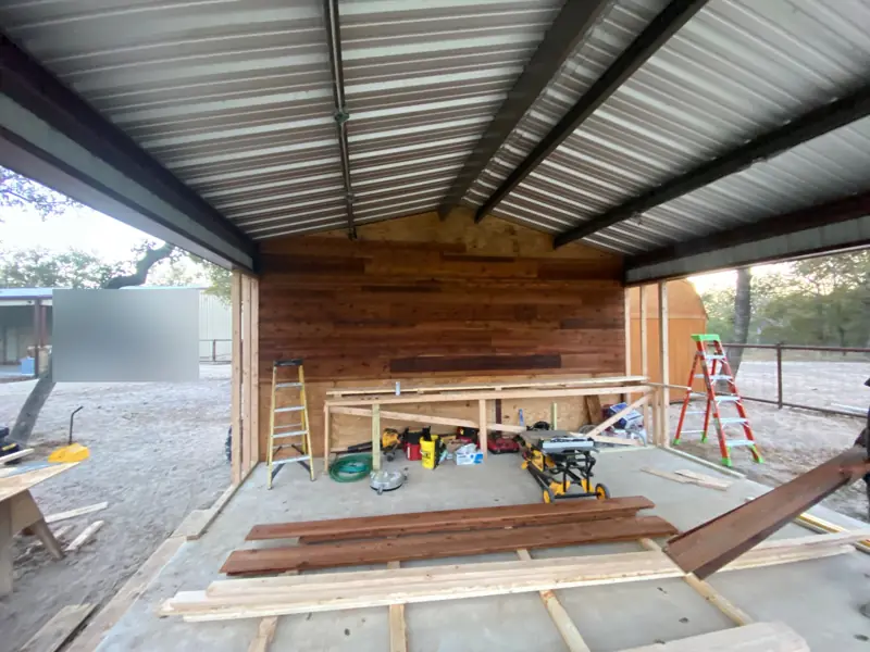 Reclaimed wood wall and counter framing under the metal roof.