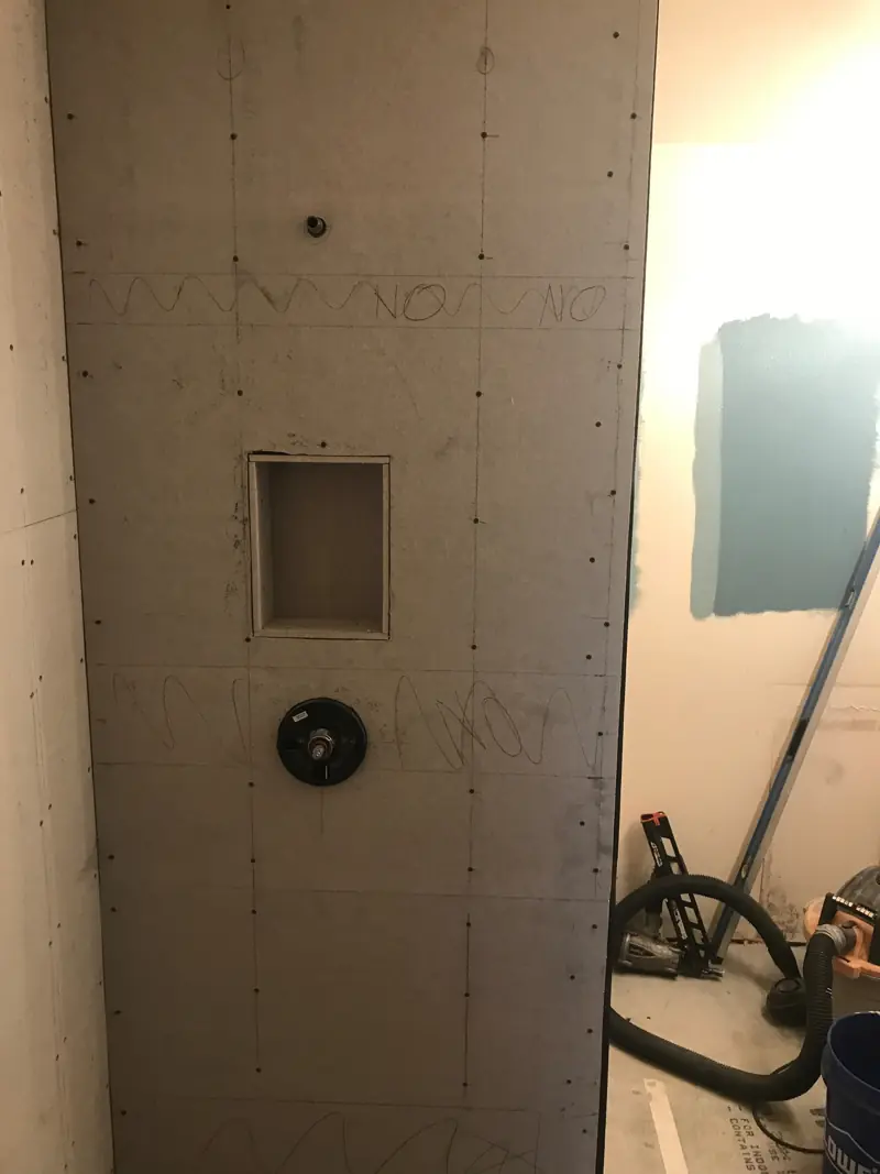 Shower wall in cement backer board, with a niche framed in and the valve in place.